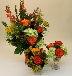 One bouquet  and two arrangements in bright fall tones