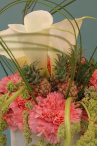 Tiny miniature pineapples in a flower arrangement