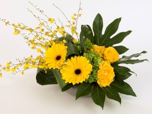 Yellow roses, gerbera and orchids in a stylish design