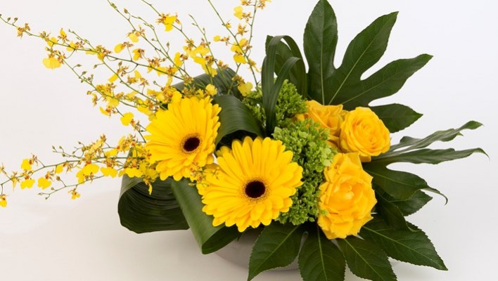 Yellow roses, gerbera and orchids in a stylish design