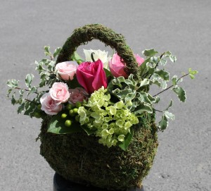 Feminine floral design in a purse made of moss